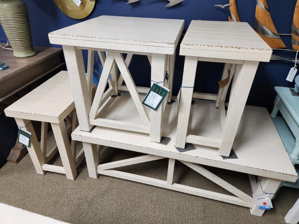 three tables and stools are on display in a store