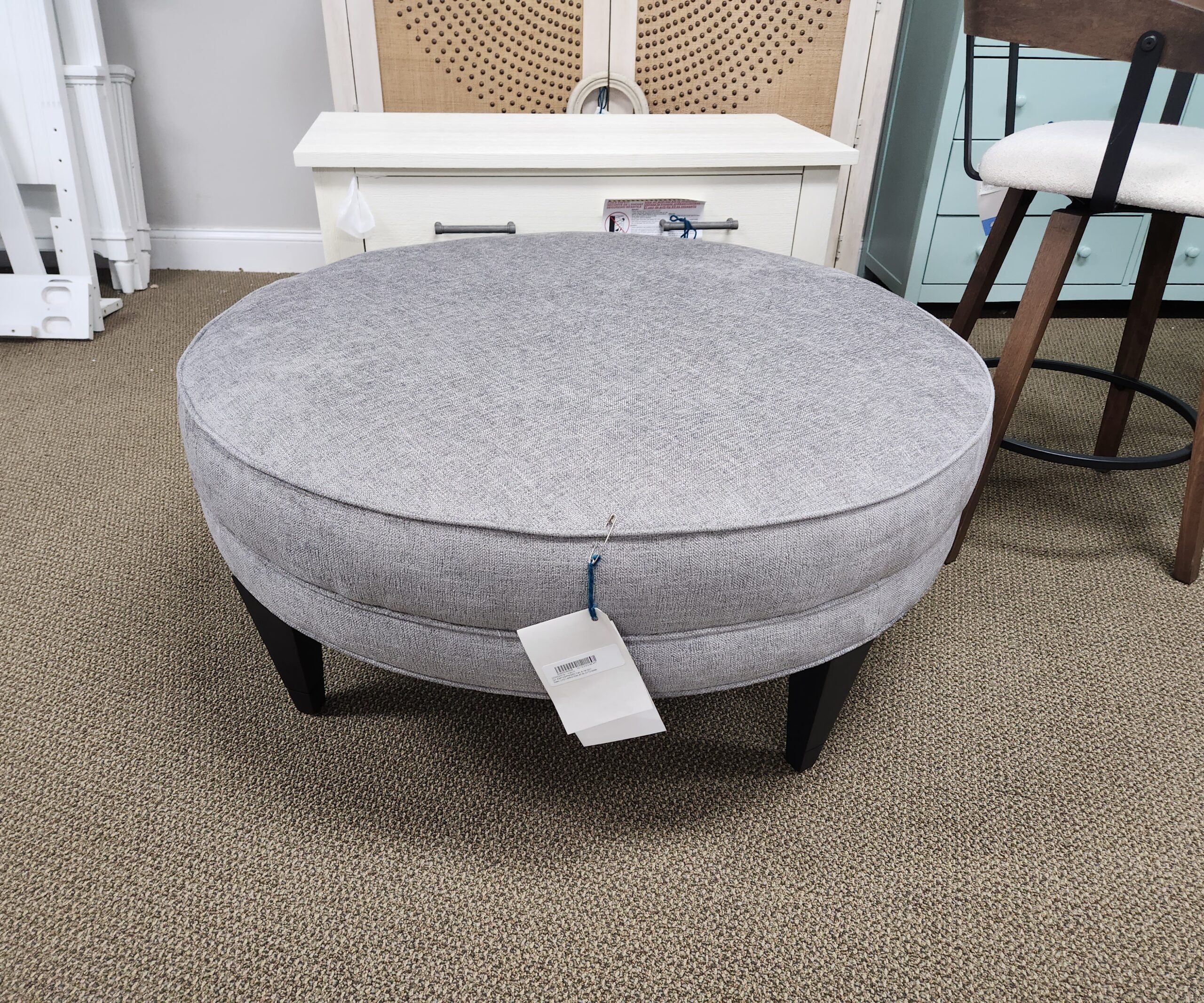 a round ottoman with a price tag on it