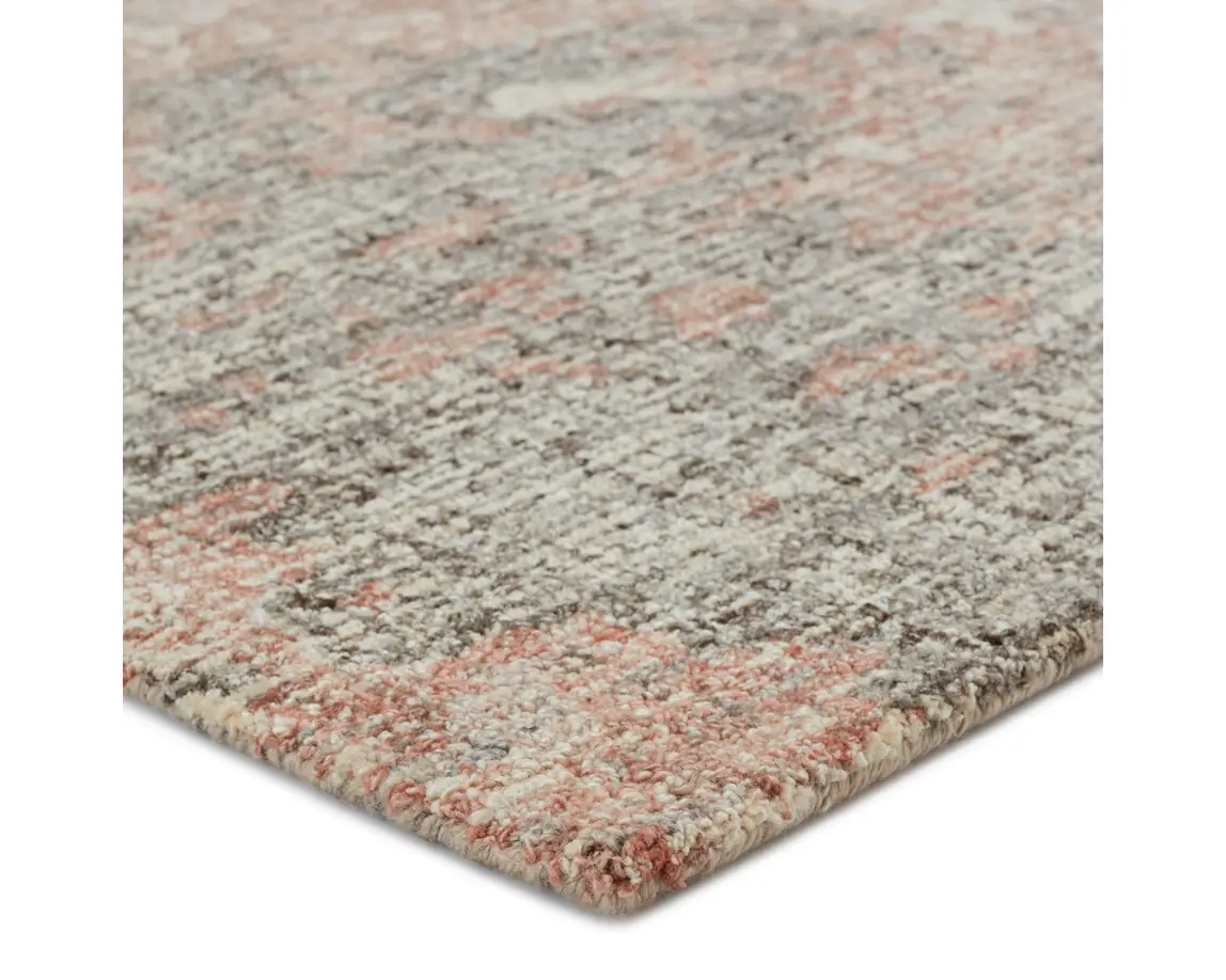 a gray and pink rug on a white background