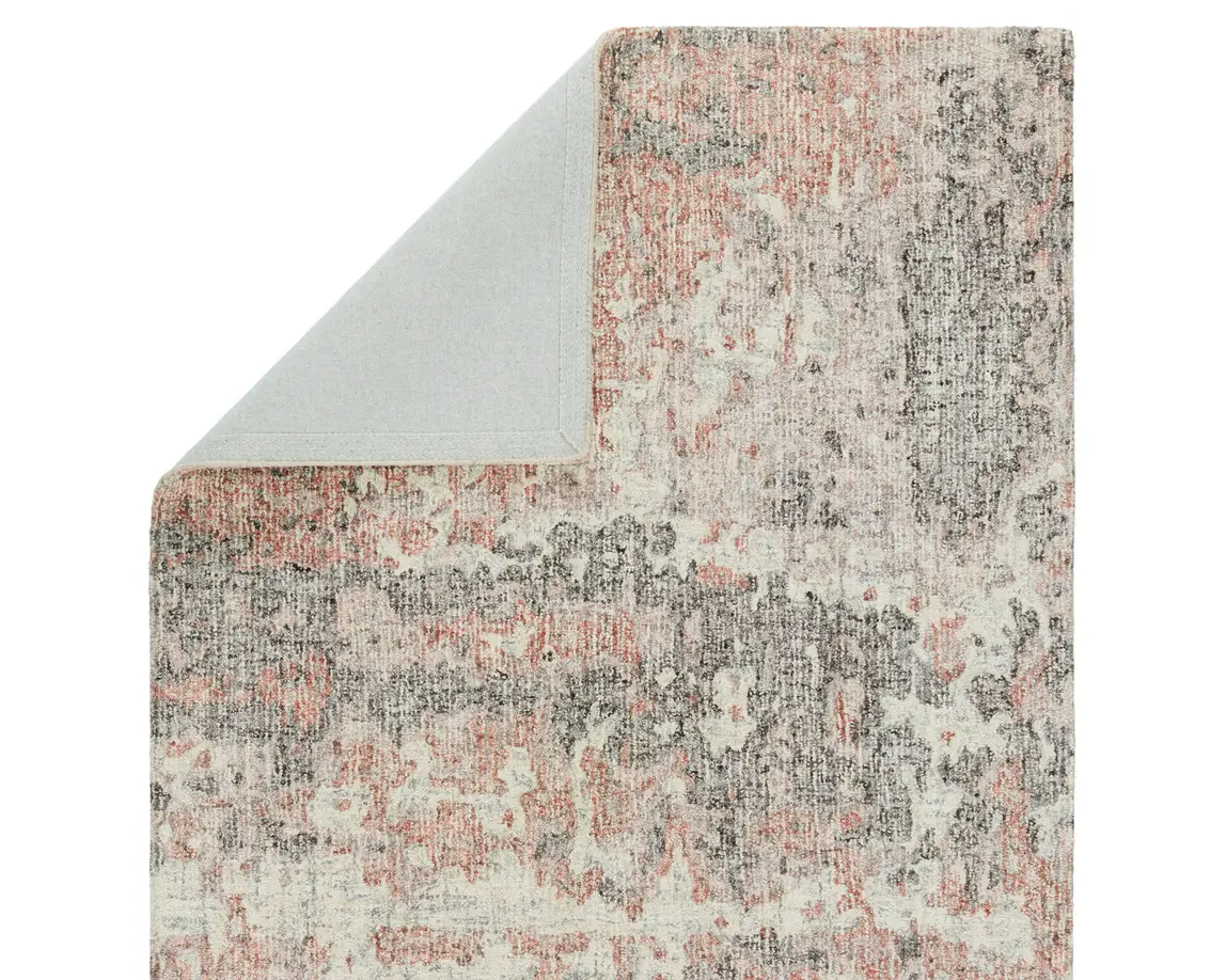 an area rug with pink and grey colors