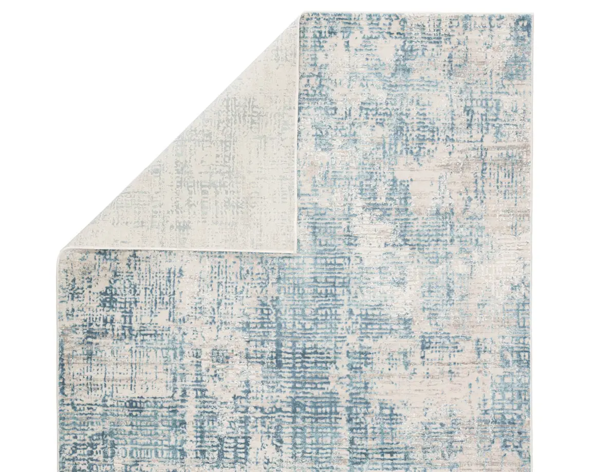 a blue and white area rug with an abstract design