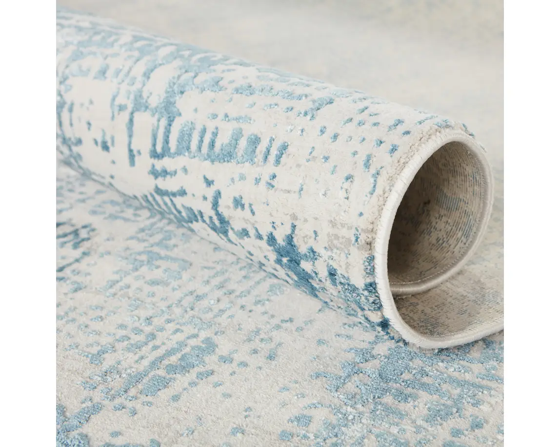 a blue and white rug with an abstract design