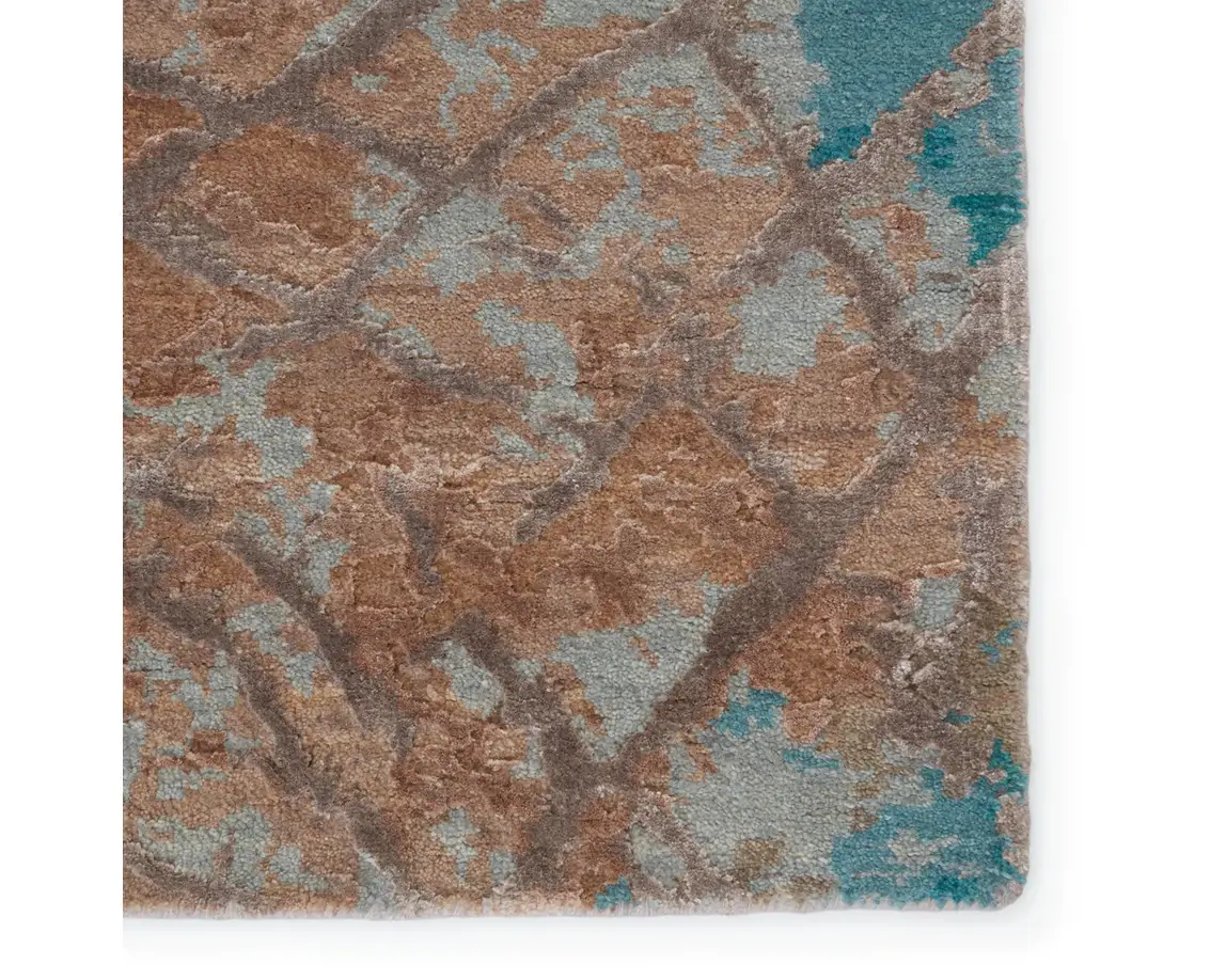 a brown and blue rug on a white background