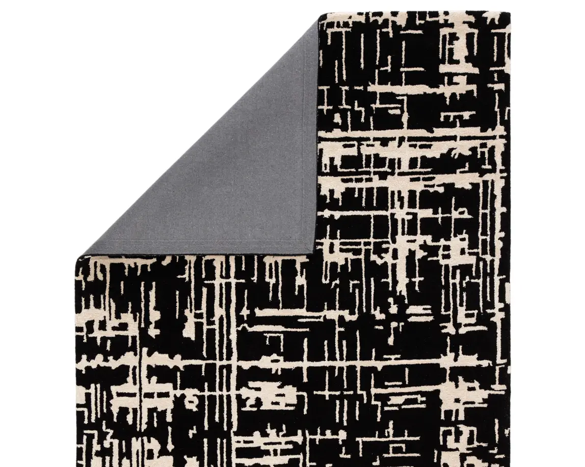 a black and white rug with a gray border
