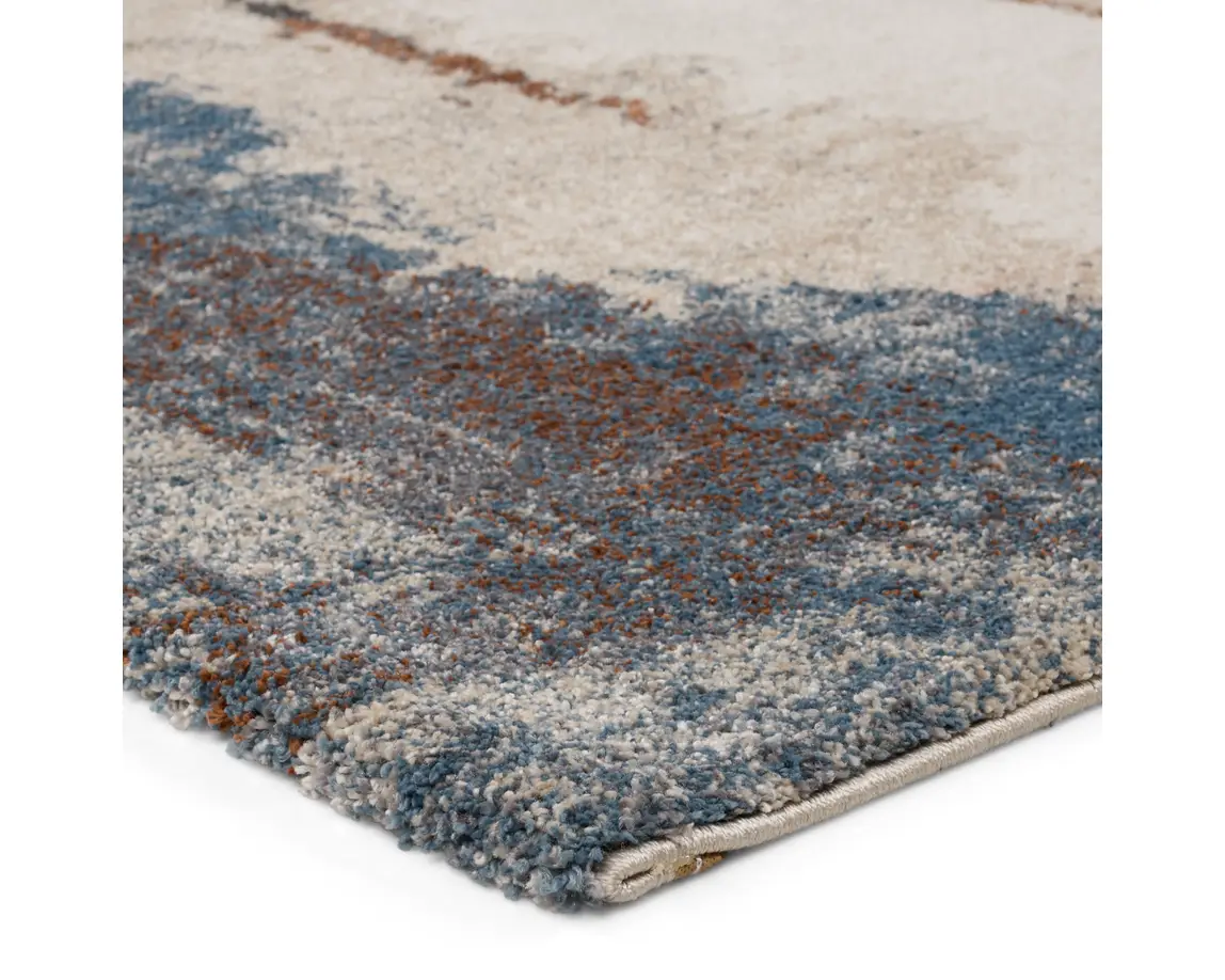 a blue and white rug with brown accents