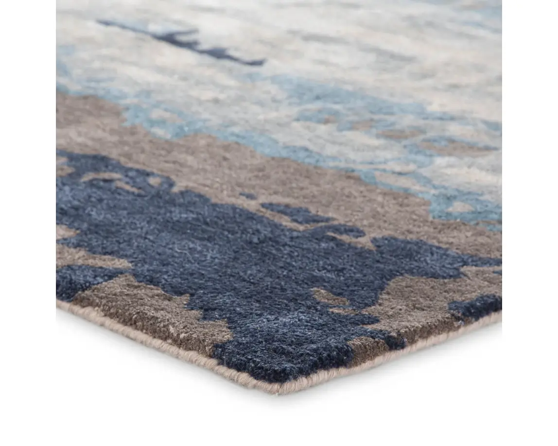 a blue and gray rug with an abstract design
