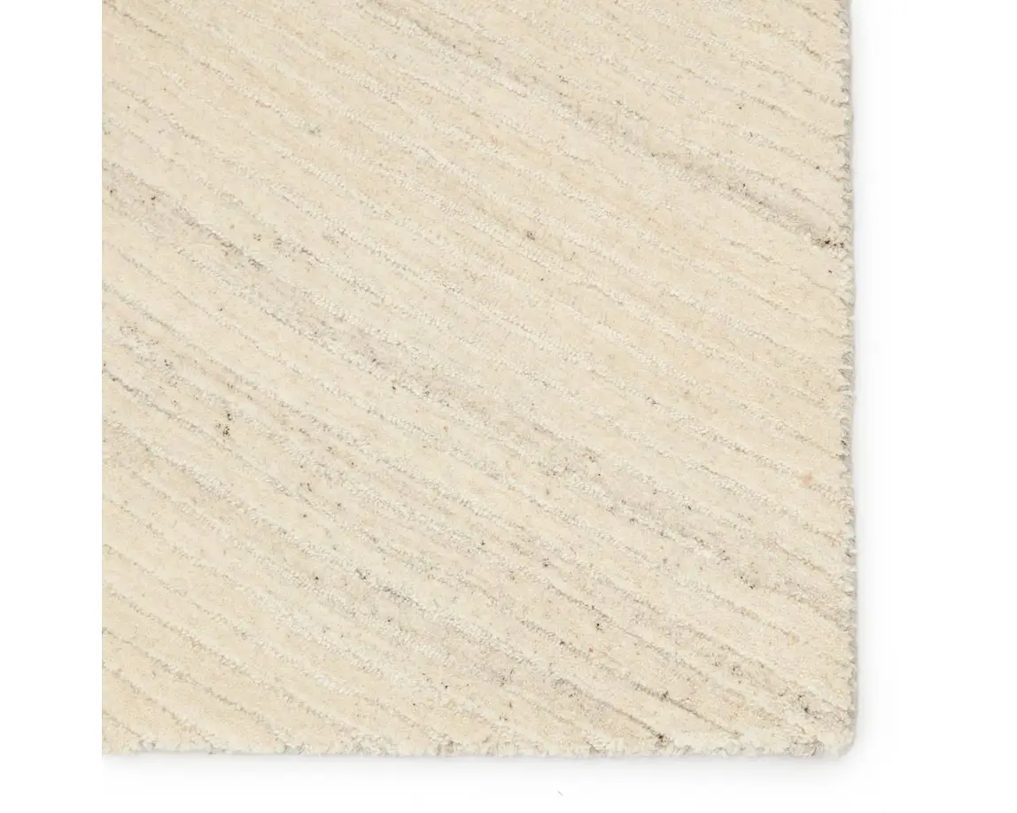 a beige rug with white stripes on it