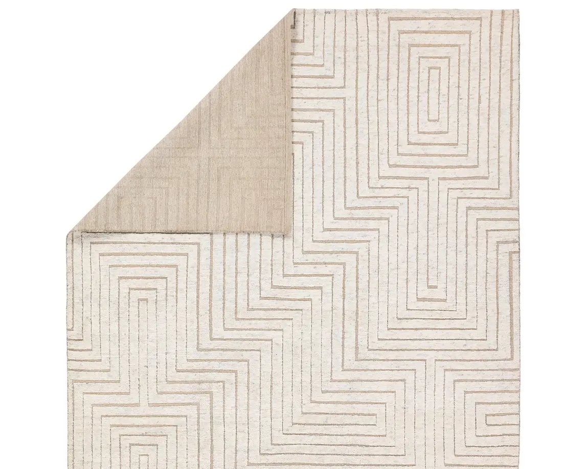 a white rug with an abstract design on it