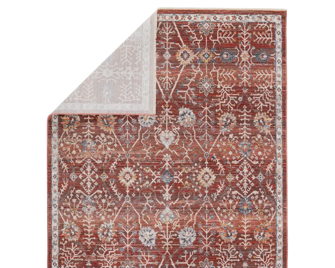 a red rug with an intricate design on it