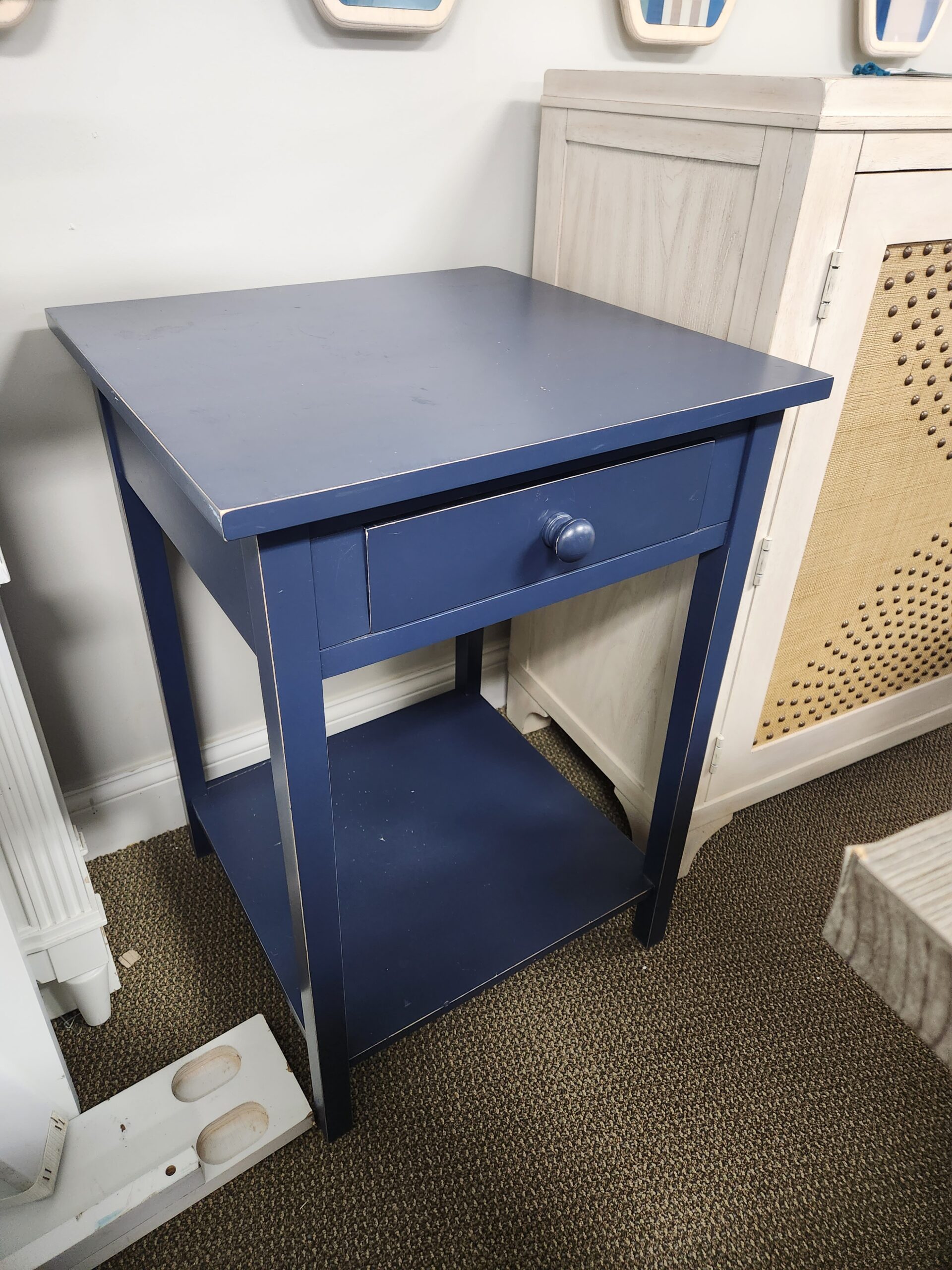 a blue cabinet with a door open on the floor