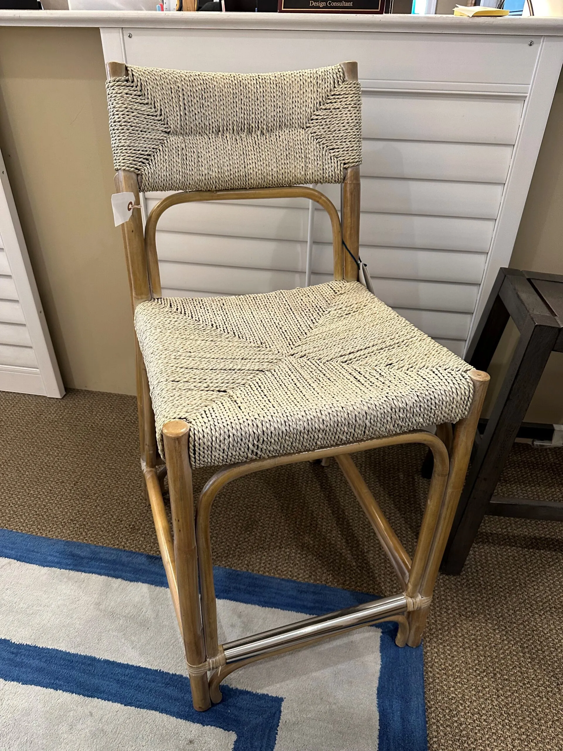 a chair sitting on a rug in front of a desk