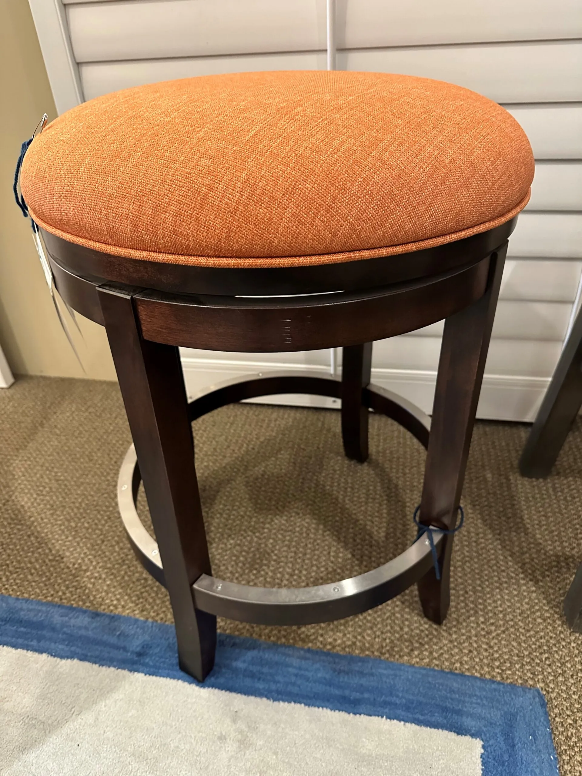 a stool with a cushion on top of it