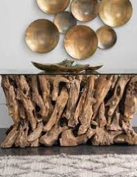 a table made out of drift wood with metal discs on top