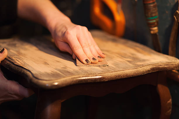 a person with their hands on a wooden table