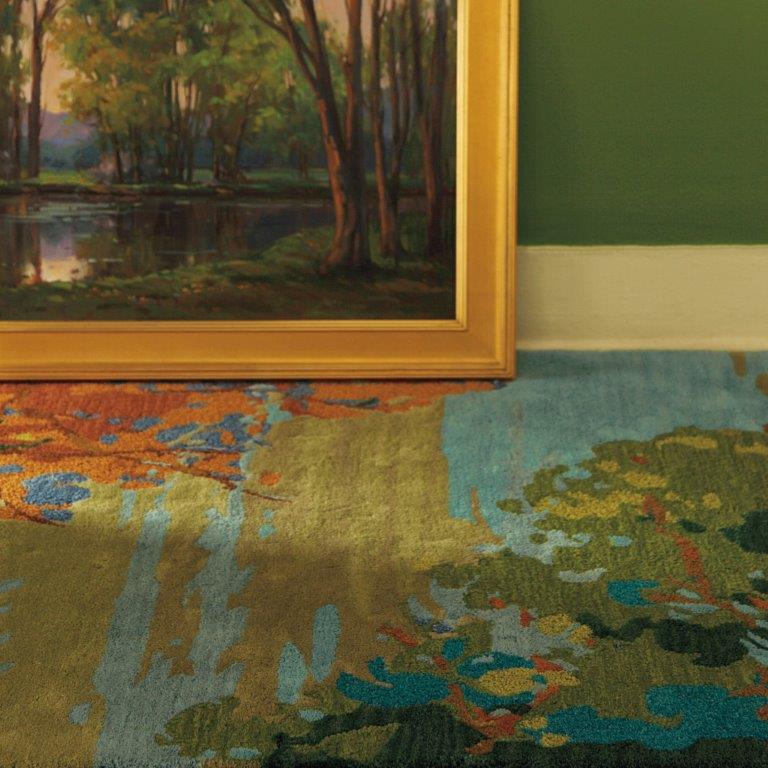 a painting is hanging on the wall next to a rug
