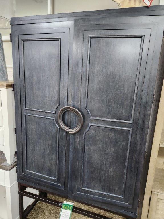an armoire with a metal ring on it