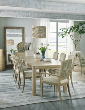 a dining room table with chairs and a rug