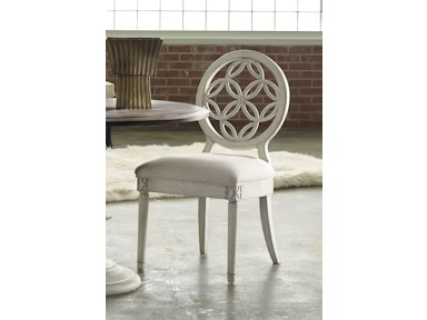a white chair with a circular back and seat