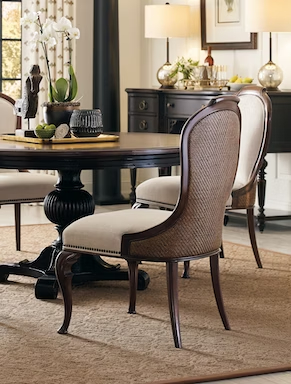 a dining room table with chairs and a mirror