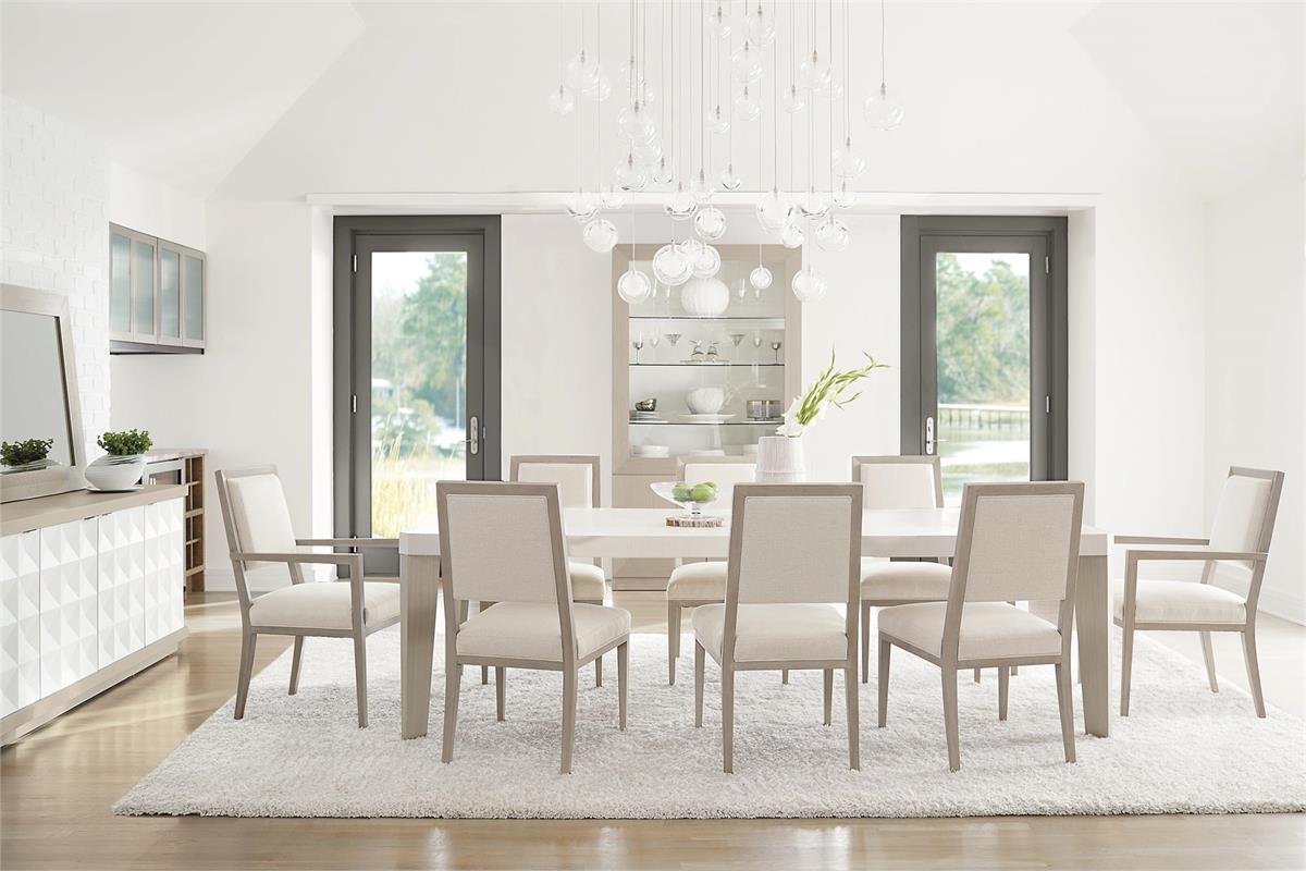 a dining room table with chairs and a chandelier