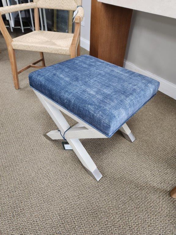 a blue bench sitting on top of a carpeted floor
