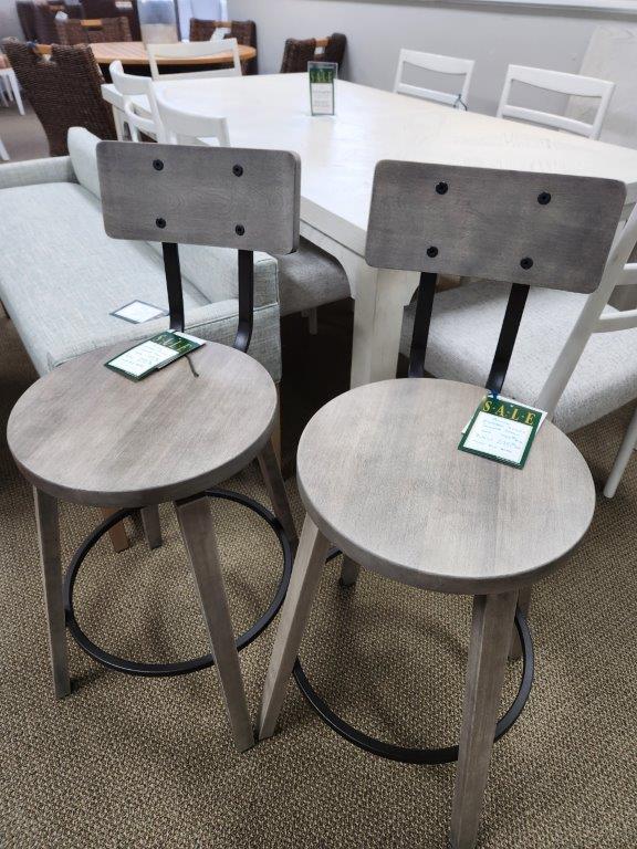 two chairs with tags on them sitting in front of a table