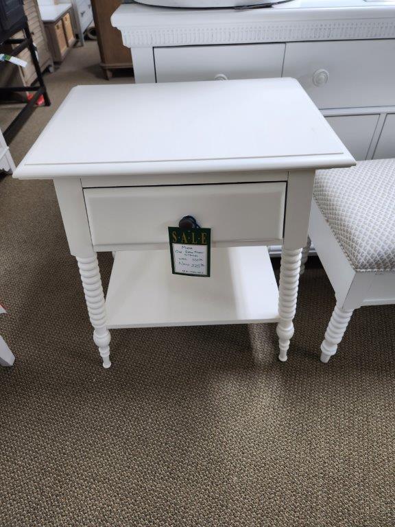a white table with a small drawer on it