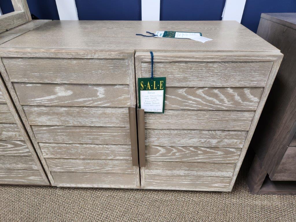 a wooden dresser with a sale tag on it