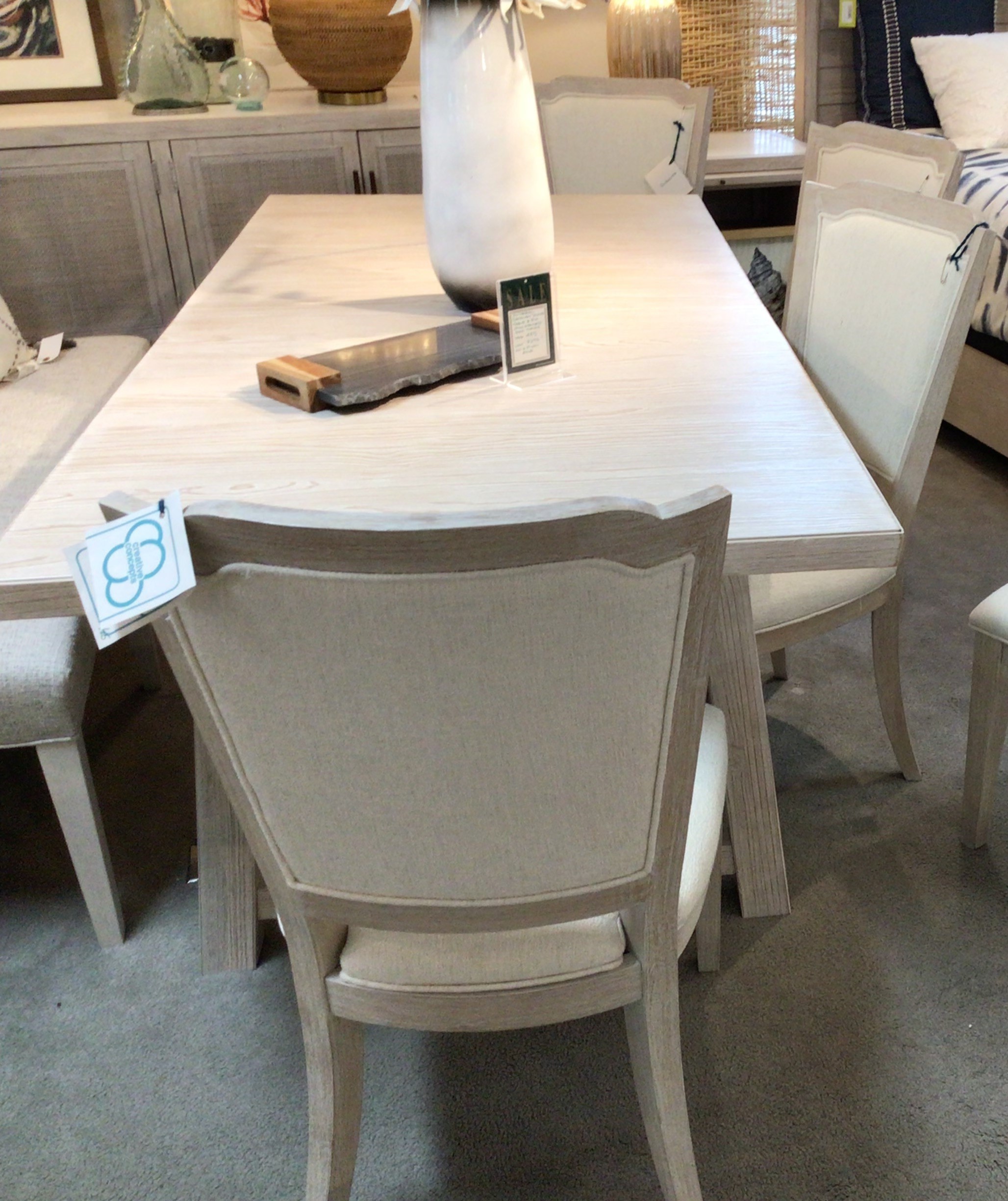 a table with chairs and a vase on it