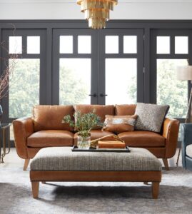 a living room filled with furniture and a chandelier