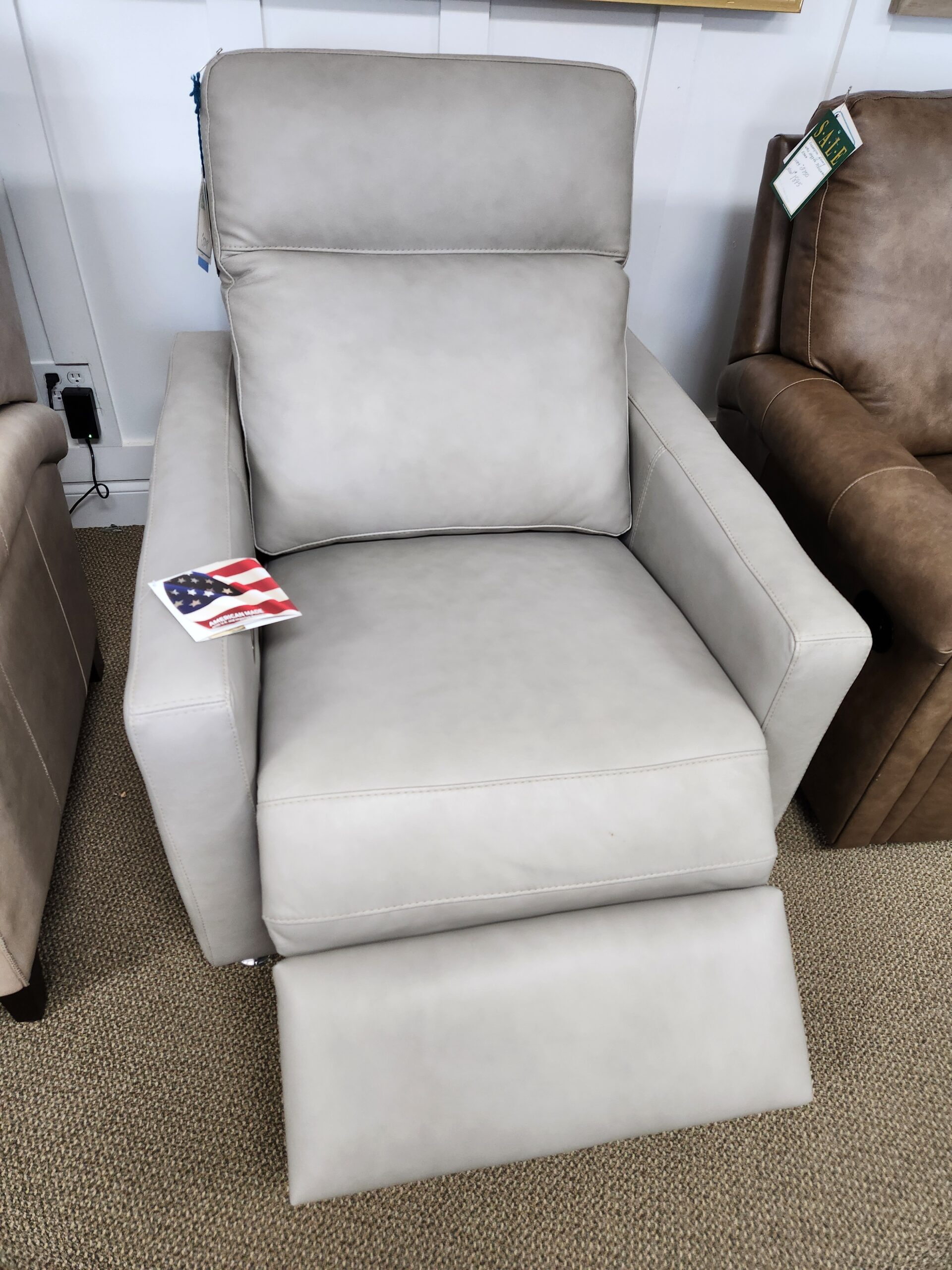 a living room with a couch, chair and ottoman