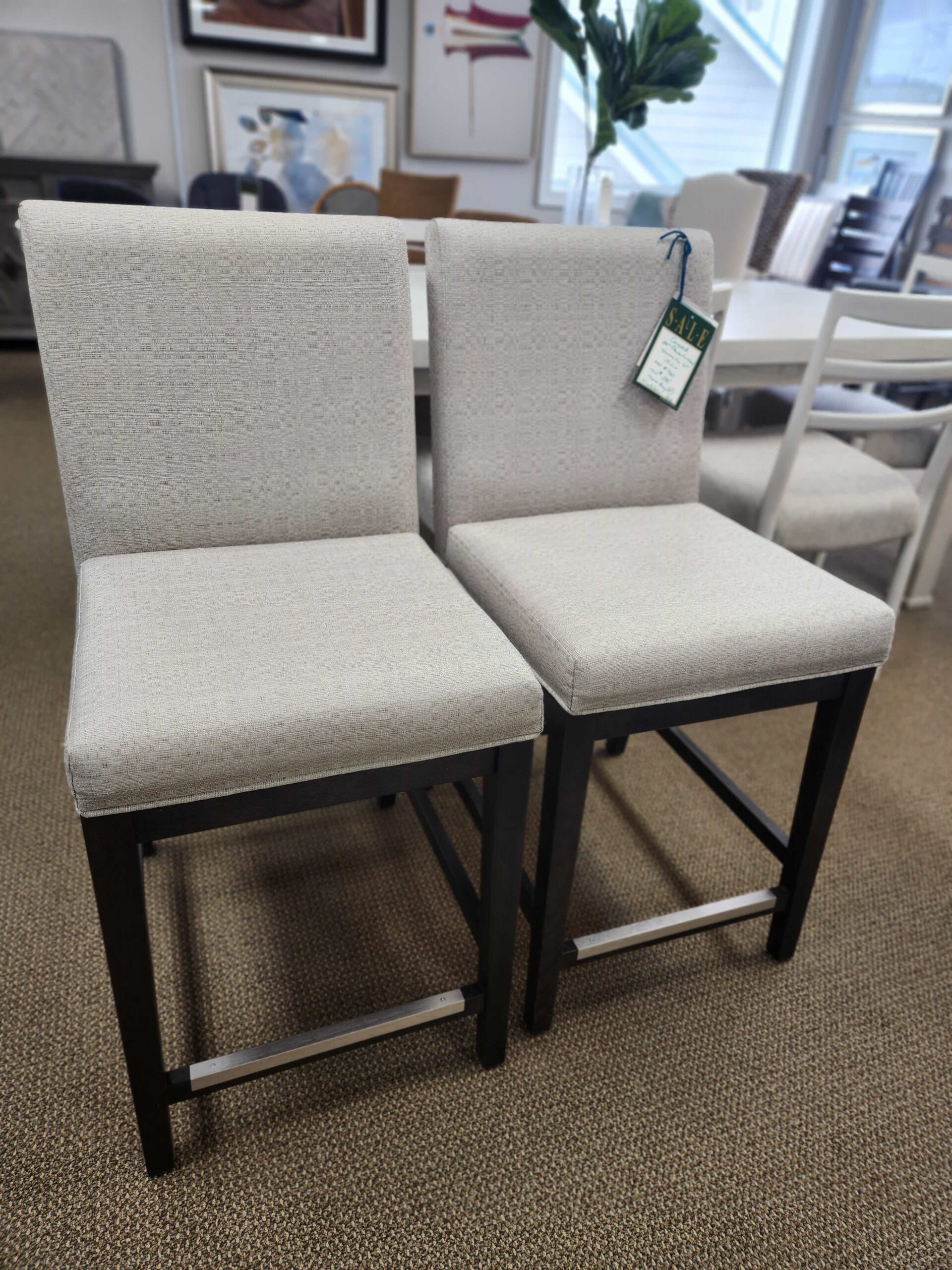 a couple of white chairs sitting next to a window