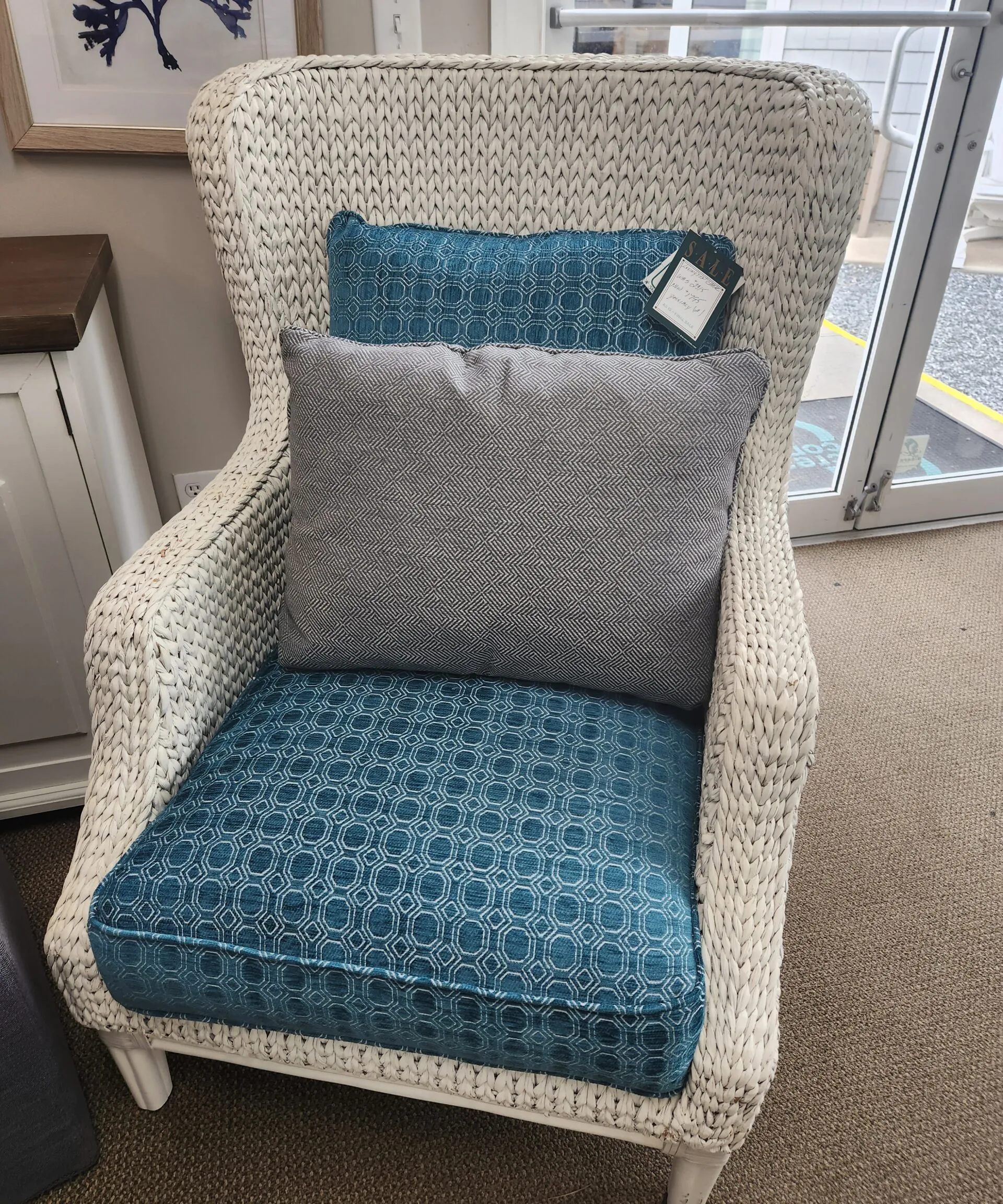 a chair with a pillow on it in a room