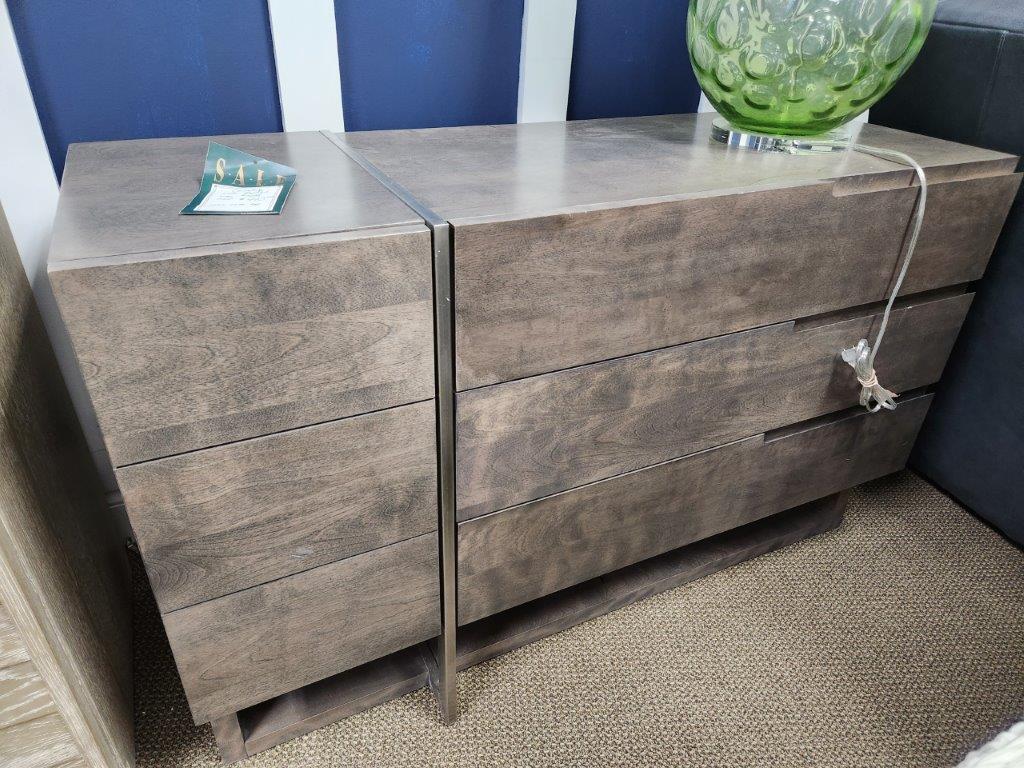 a wooden dresser sitting next to a blue wall