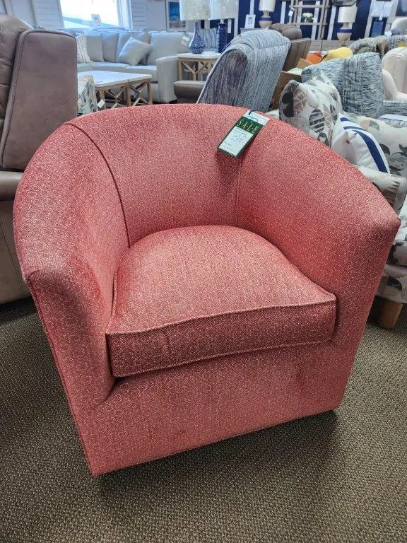 a red chair sitting in a room filled with furniture