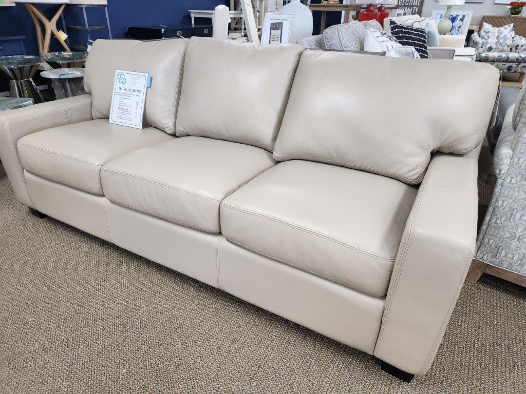 a white leather couch in a store