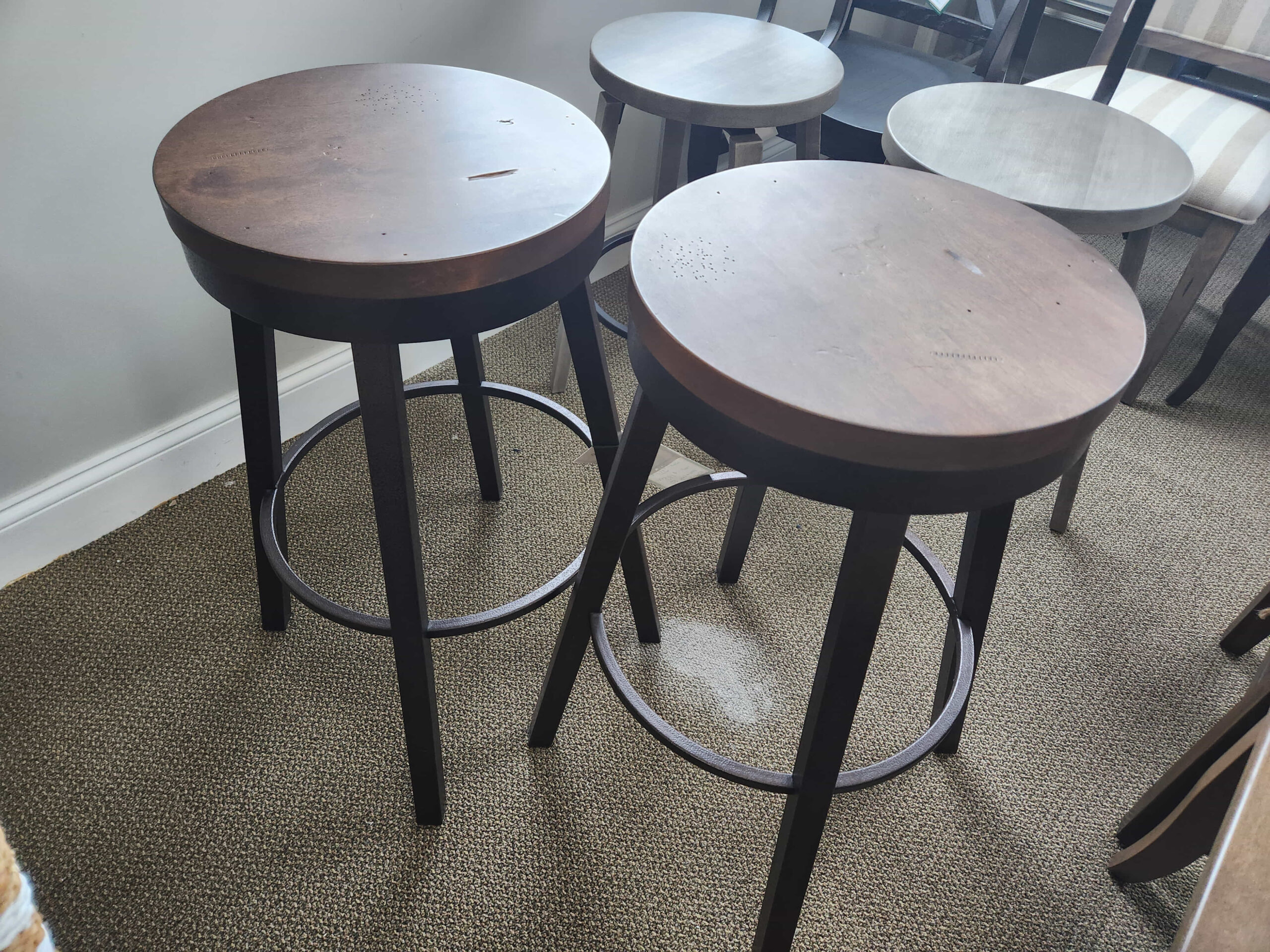 four stools and a table in a room