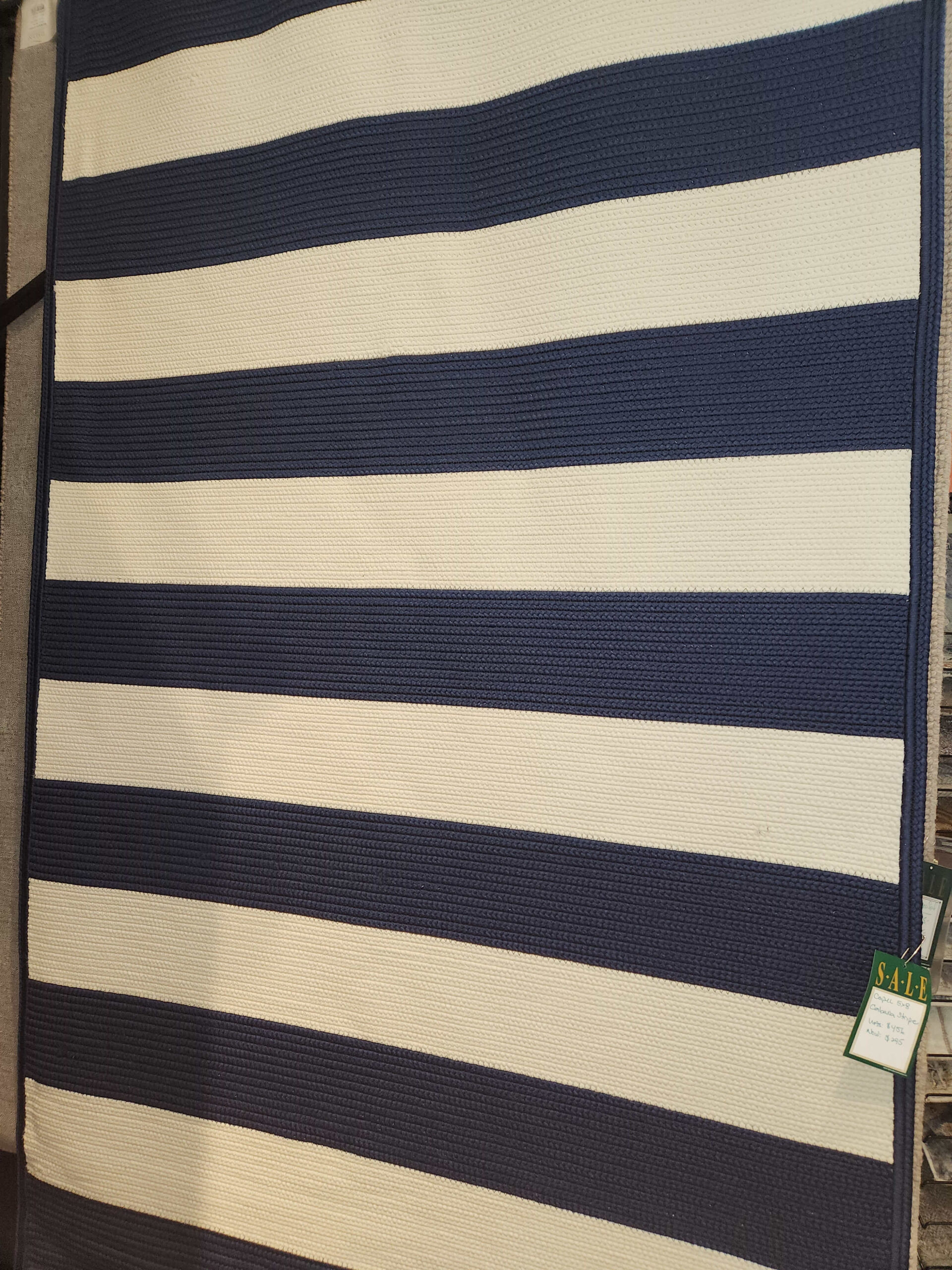 a blue and white striped bag sitting on top of a table