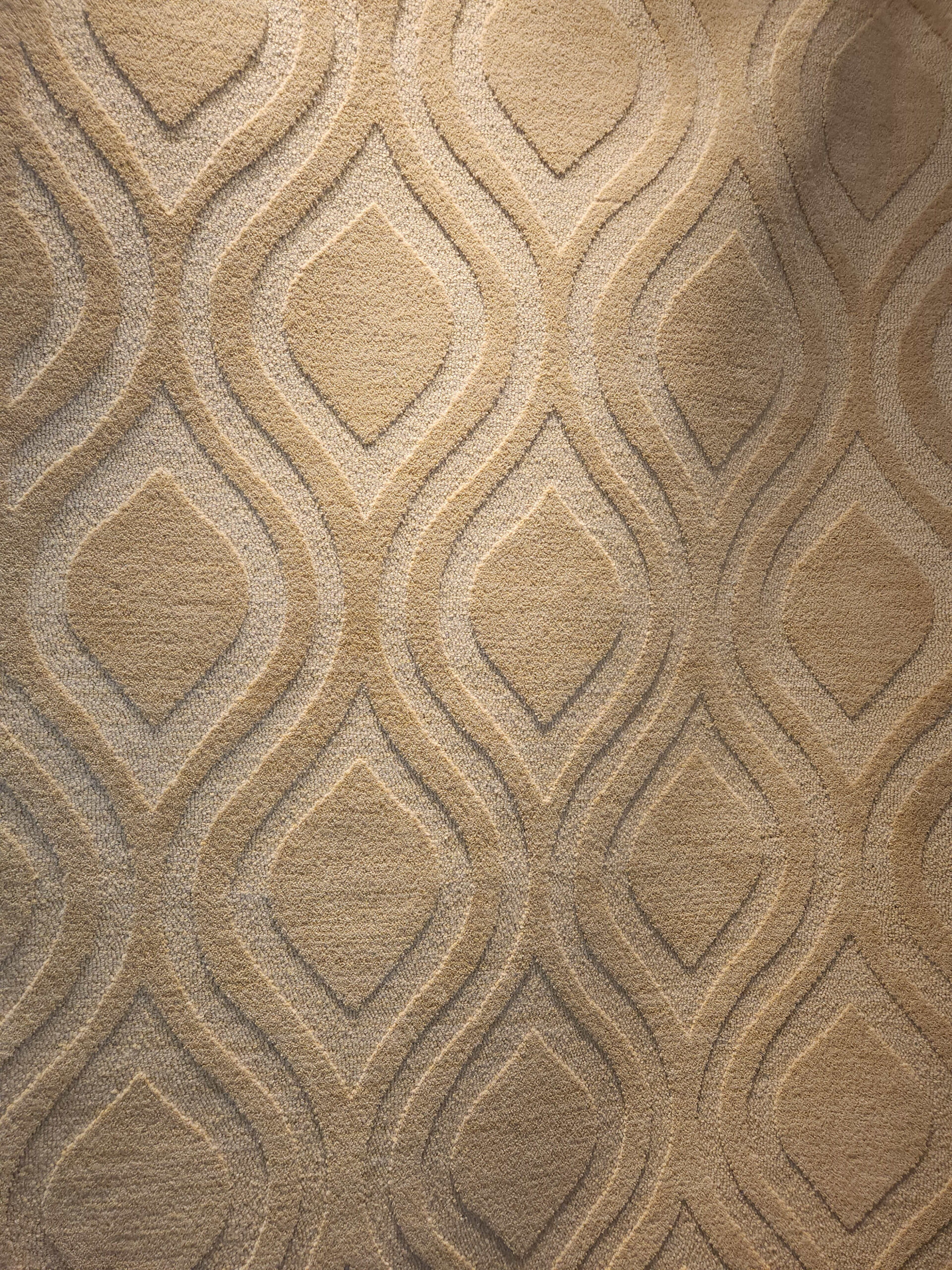 a beige carpet with a wavy pattern on it