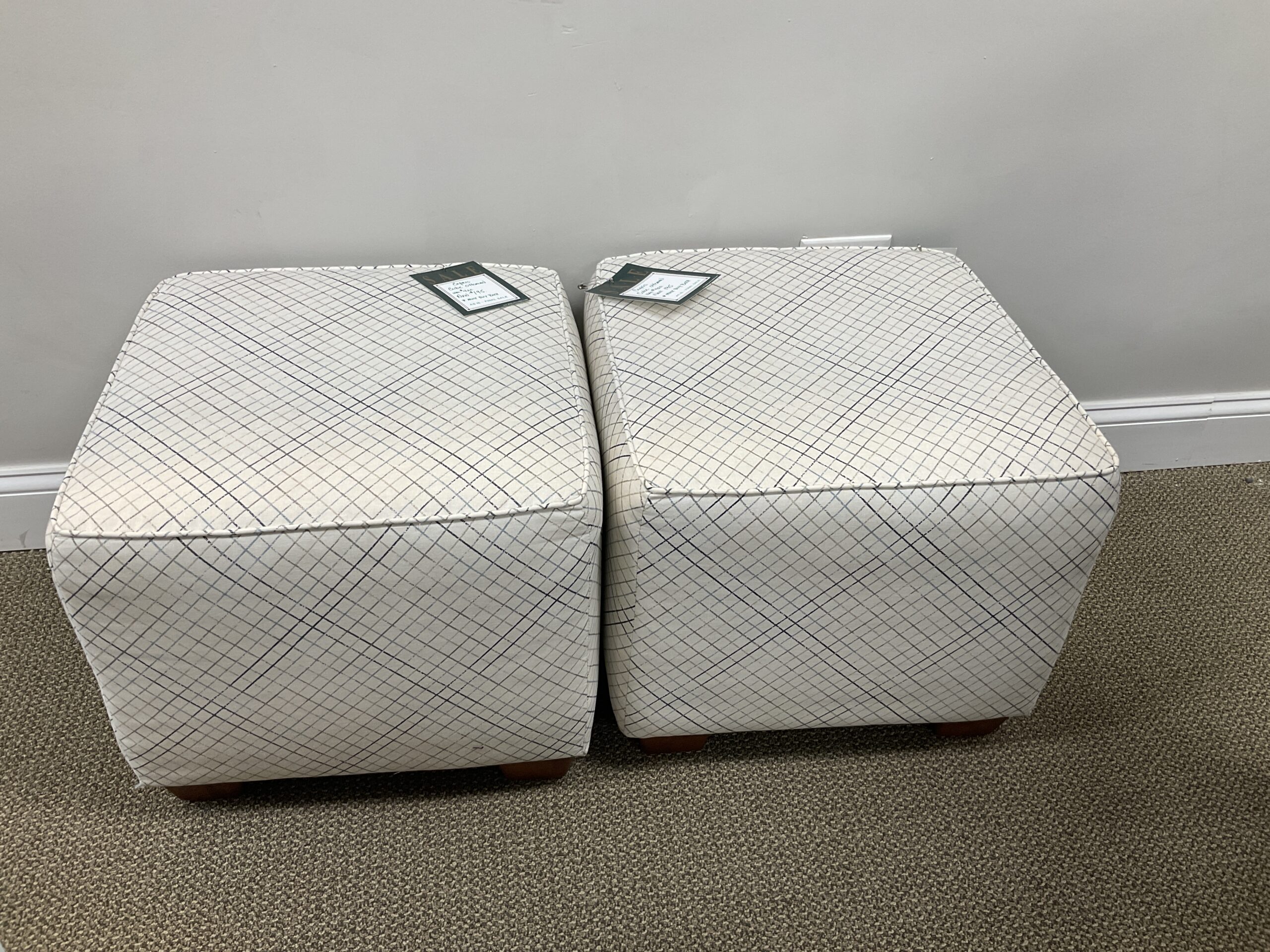 a pair of white cube ottomans in a room