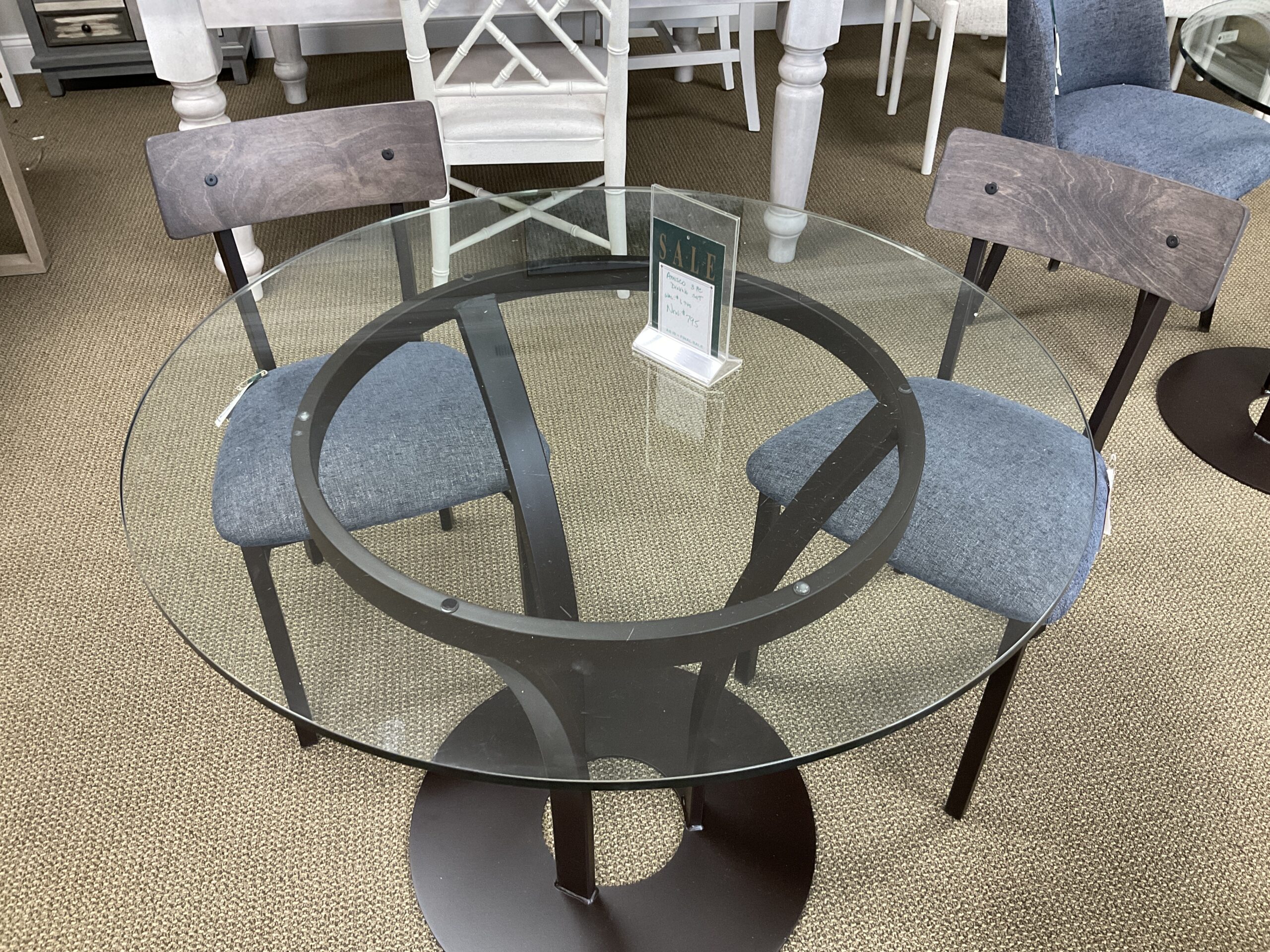 a glass table with chairs around it