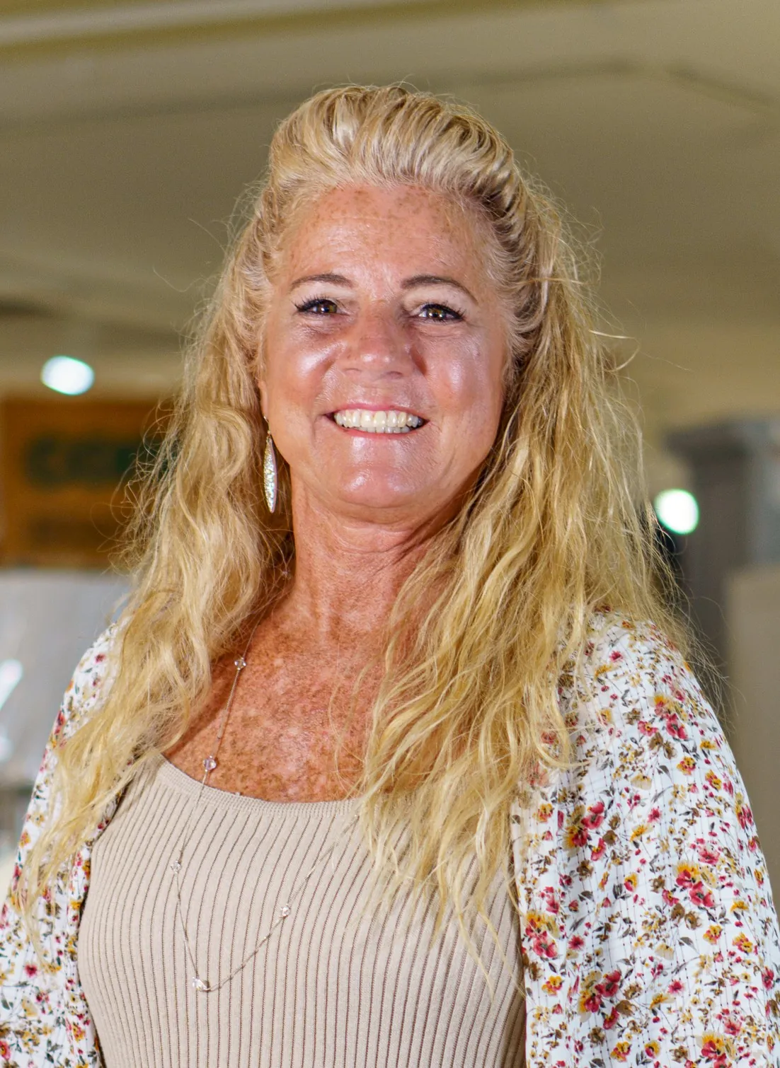 a woman with long blonde hair is smiling